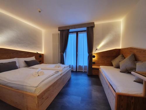 Postel nebo postele na pokoji v ubytování Hotel Pezzotti