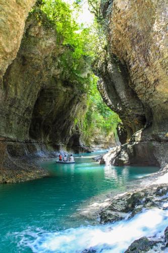 a group of people in a boat in a river at GARDENIE in Kutaisi