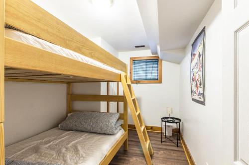 a bedroom with two bunk beds and a ladder at Mountain Trail Chalet in Blue Mountains
