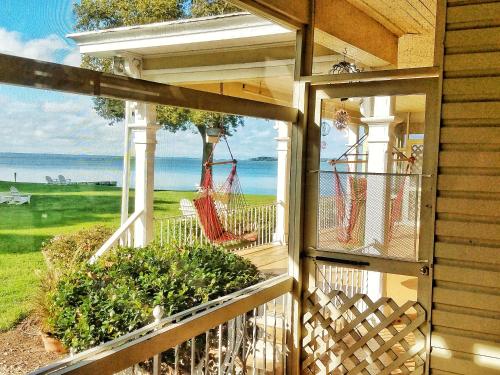a screened in porch with a view of the ocean at Sandaway Suites & Beach in Oxford