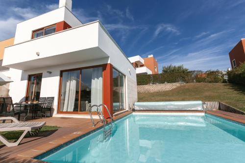 a villa with a swimming pool and a house at Villa Lantana in Vau