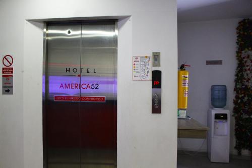a door to a hotel with a sign on it at Hotel America 52 in Rionegro