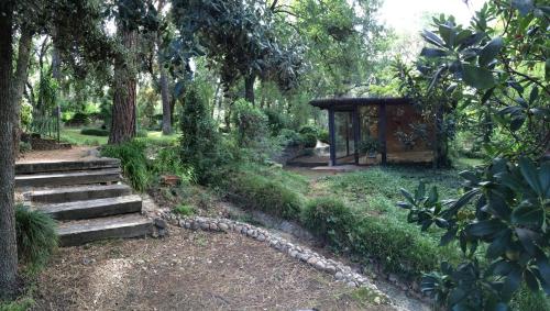 a garden with stairs and a gazebo at La Bruguera de Púbol Villa & Eco Retreat Centre in Púbol