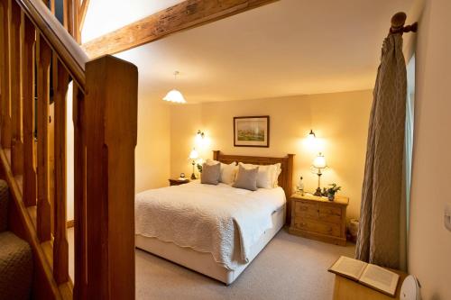 Un dormitorio con una cama grande y dos mesitas de noche. en Finest Retreats - Bretherdale Hall, en Tebay