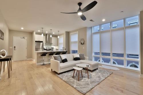 a living room with a white couch and a kitchen at *New* XquisiteMidCenturyM0d~ Condo *OTR* w/Parking in Cincinnati