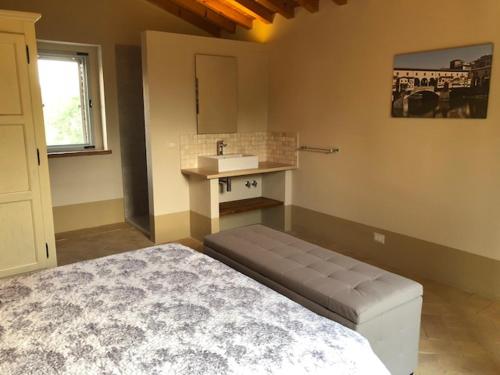 a bedroom with a bed and a sink in it at Piccolo Borgo Gagnoni in Sinalunga