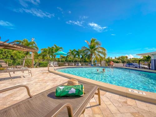 a pool at a resort with a table and chairs at Sun Outdoors Marathon in Marathon