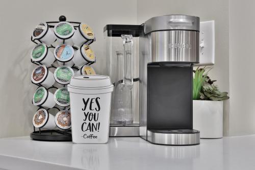 a coffee maker and a cup on a counter at *New* XquisiteMidCenturyM0d~ Condo *OTR* w/Parking in Cincinnati