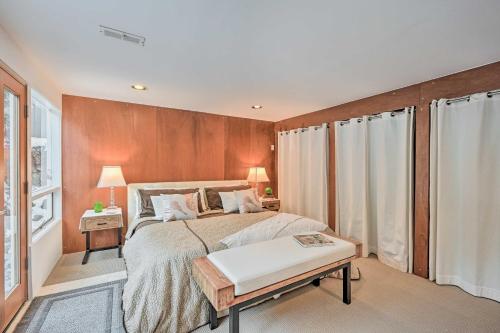 a bedroom with a bed with a wooden wall at Edmonds Apartment with Private Wine Cellar! in Edmonds