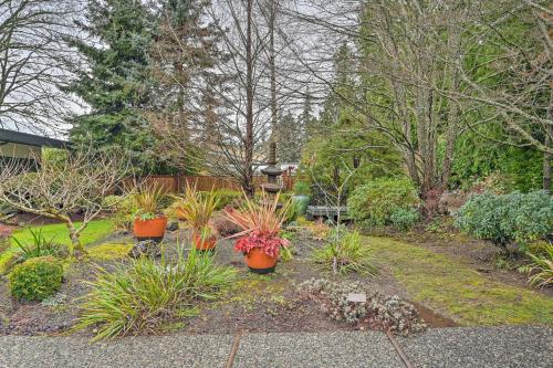 a garden with pots of plants in a yard at Edmonds Apartment with Private Wine Cellar! in Edmonds
