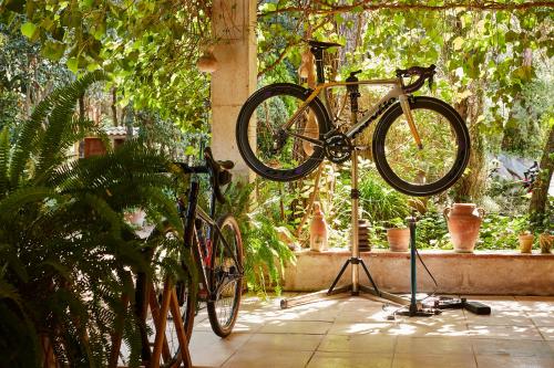 a bike on a stand in a room with plants at La Bruguera de Púbol Villa & Eco Retreat Centre in Púbol