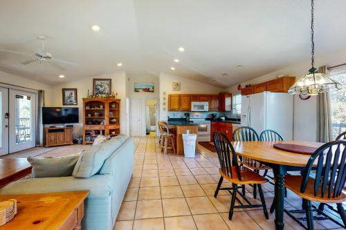 a living room with a couch and a table and a kitchen at Seaside Searenity in Indian Pass