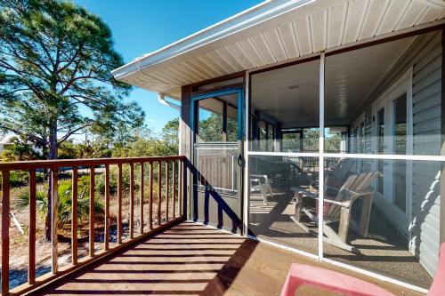 a porch of a house with glass doors at Seaside Searenity in Indian Pass