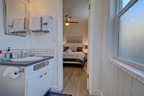 a bathroom with a sink and a bed in a room at 18th Street D in Boise