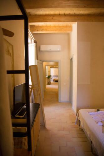 a view of a room with a bed and a hallway at Locanda Carra Manna in Sassari