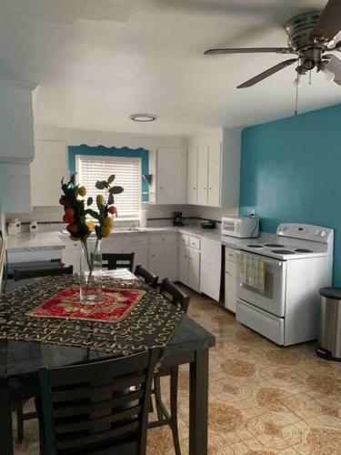 a kitchen with a table with a vase of flowers on it at Remodeled House Minutes to Falls Attractions in Niagara Falls