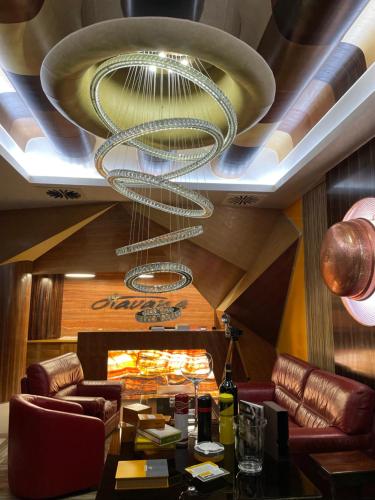 a ceiling with a chandelier in a restaurant at Hotel Havana Loznica in Loznica