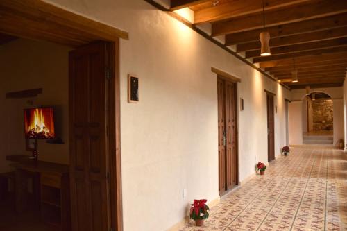 an empty hallway of a house with a fireplace at Hotel Junvay in San Cristóbal de Las Casas