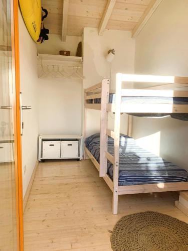 a bunk bed room with two bunk beds in it at La Vela Summer House - FREE WIFI - 700mt from the beach in Costa Rei