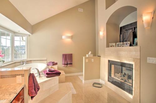 a bathroom with a fireplace and a tub and a sink at Secluded Home with Pool about 14 Mi to Coeur dAlene! in Post Falls