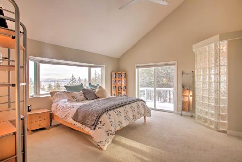 a bedroom with a bed and a large window at Secluded Home with Pool about 14 Mi to Coeur dAlene! in Post Falls