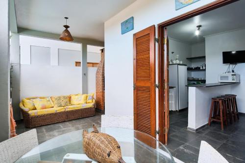 a living room with a glass table and a couch at Chalés Mirante da Lagoinha in Ubatuba