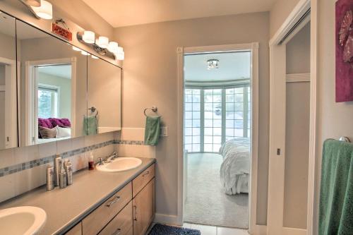 a bathroom with a sink and a mirror and a bed at Secluded Home with Pool about 14 Mi to Coeur dAlene! in Post Falls