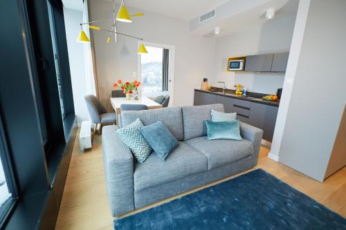 a living room with a couch and a kitchen at Aparthotel Park - By The Sea in Gdynia