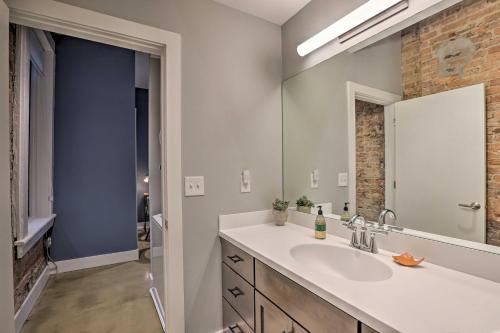 a bathroom with a sink and a mirror at Sleek Studio Near Dtwn Dining and Entertainment in Cincinnati
