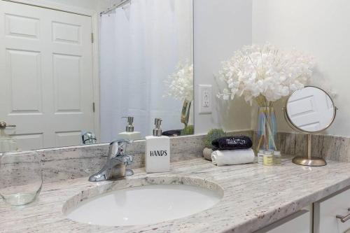 a bathroom counter with a sink and a mirror at Book Cozy King Bed Now 25 Percent OFF Spring Special! in Carteret