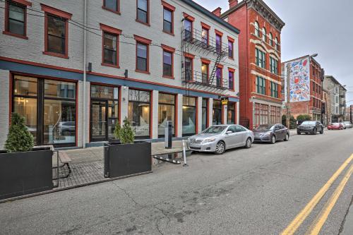 a city street with cars parked in front of buildings at Sleek Studio Near Dtwn Dining and Entertainment in Cincinnati