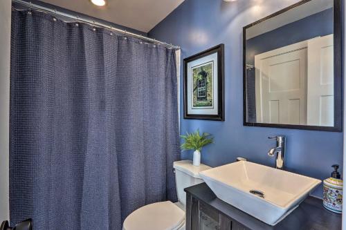 a blue bathroom with a sink and a toilet at Morrisonville Manor with Fire Pit and Hot Tub! in Britain