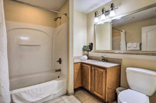 a bathroom with a tub and a toilet and a sink at Orlando Condo with Pool about 1 Mi to Disney! in Orlando