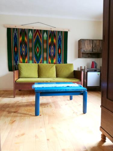 a living room with a couch and a table at Podołynia in Dwernik