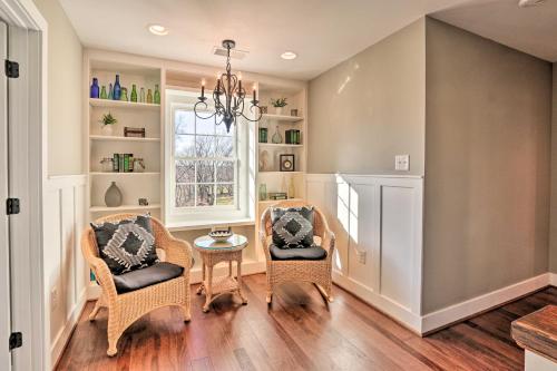 a dining room with two chairs and a table at Morrisonville Manor with Fire Pit and Hot Tub! in Britain