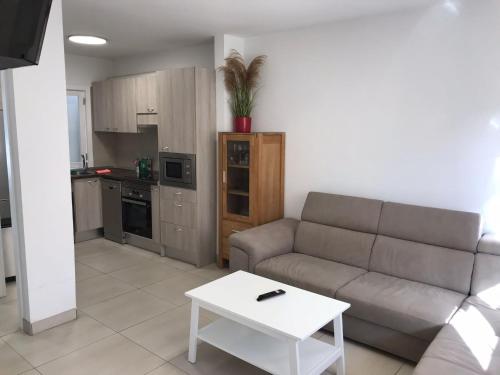 a living room with a couch and a table at Grosse Terrasse. Modern. Home office. Solarium in Los Realejos