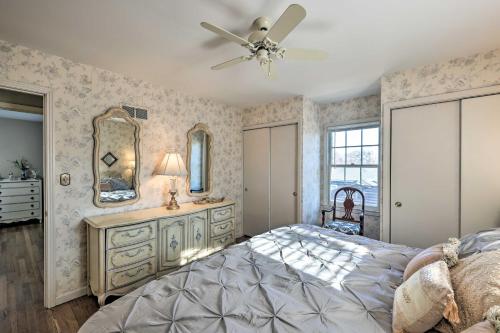 a bedroom with a bed and a dresser and a mirror at Cozy Kansas City Home with Yard - 9 Mi to Dtwn! in Kansas City