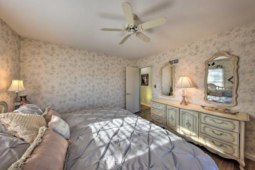 a bedroom with a bed and a ceiling fan at Cozy Kansas City Home with Yard - 9 Mi to Dtwn! in Kansas City