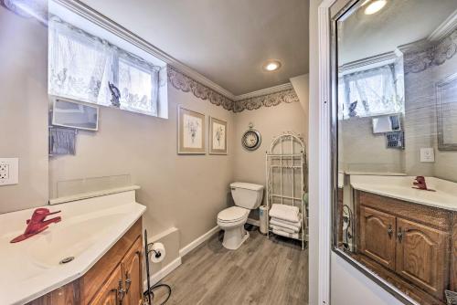a bathroom with a toilet and a sink and a shower at Cozy Kansas City Home with Yard - 9 Mi to Dtwn! in Kansas City