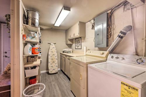 a small kitchen with a washer and dryer at Cozy Kansas City Home with Yard - 9 Mi to Dtwn! in Kansas City