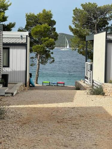 a house with a view of the water and a sail boat at Ahoi House 7 in Drage