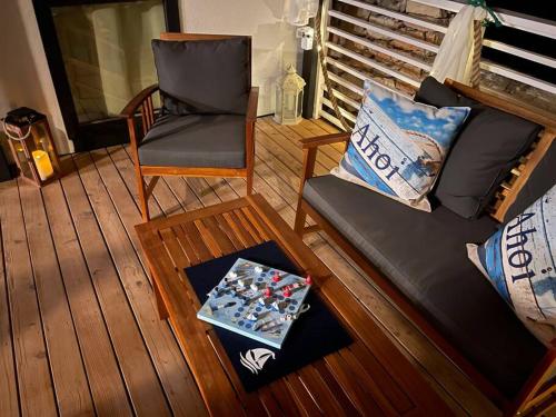 a living room with a couch and a chair at Ahoi House 7 in Drage