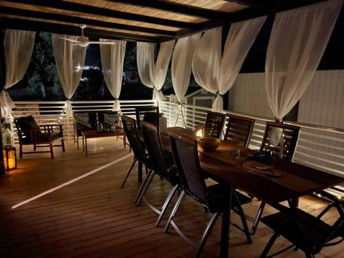 a wooden deck with a table and chairs at Ahoi House 7 in Drage
