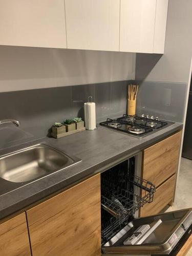 a kitchen with a sink and a stove top oven at Ahoi House 7 in Drage