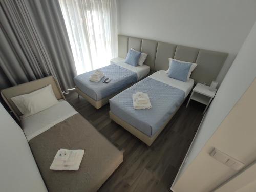 two beds in a small room with a couch and a bed at Olhar Sobre o Alva - Turismo Rural e Sabores in São Sebastião da Feira