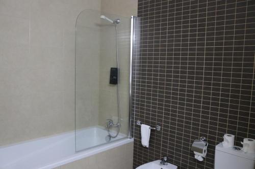 a bathroom with a shower and a toilet and a sink at Bellavista Avenida By BeGuest in Albufeira
