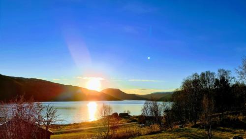 a view of a lake with the sun setting at Cabin magic on Senja, atmosphere like a fairytale in Botnhamn