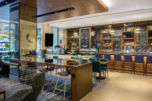 a bar in a restaurant with chairs and a counter at The Chicago Hotel Collection Magnificent Mile in Chicago