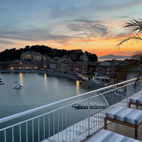a view of a river at sunset from a balcony at Hotel Helvetia in Sestri Levante