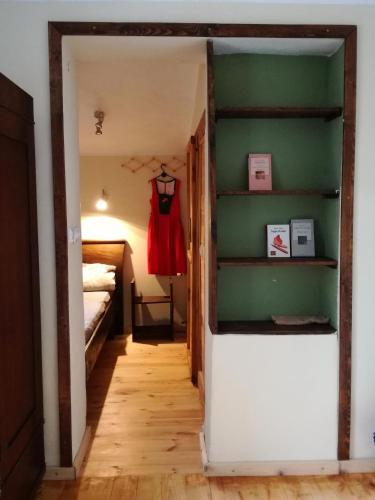 a hallway with a room with a bed and a shelf at Podołynia in Dwernik